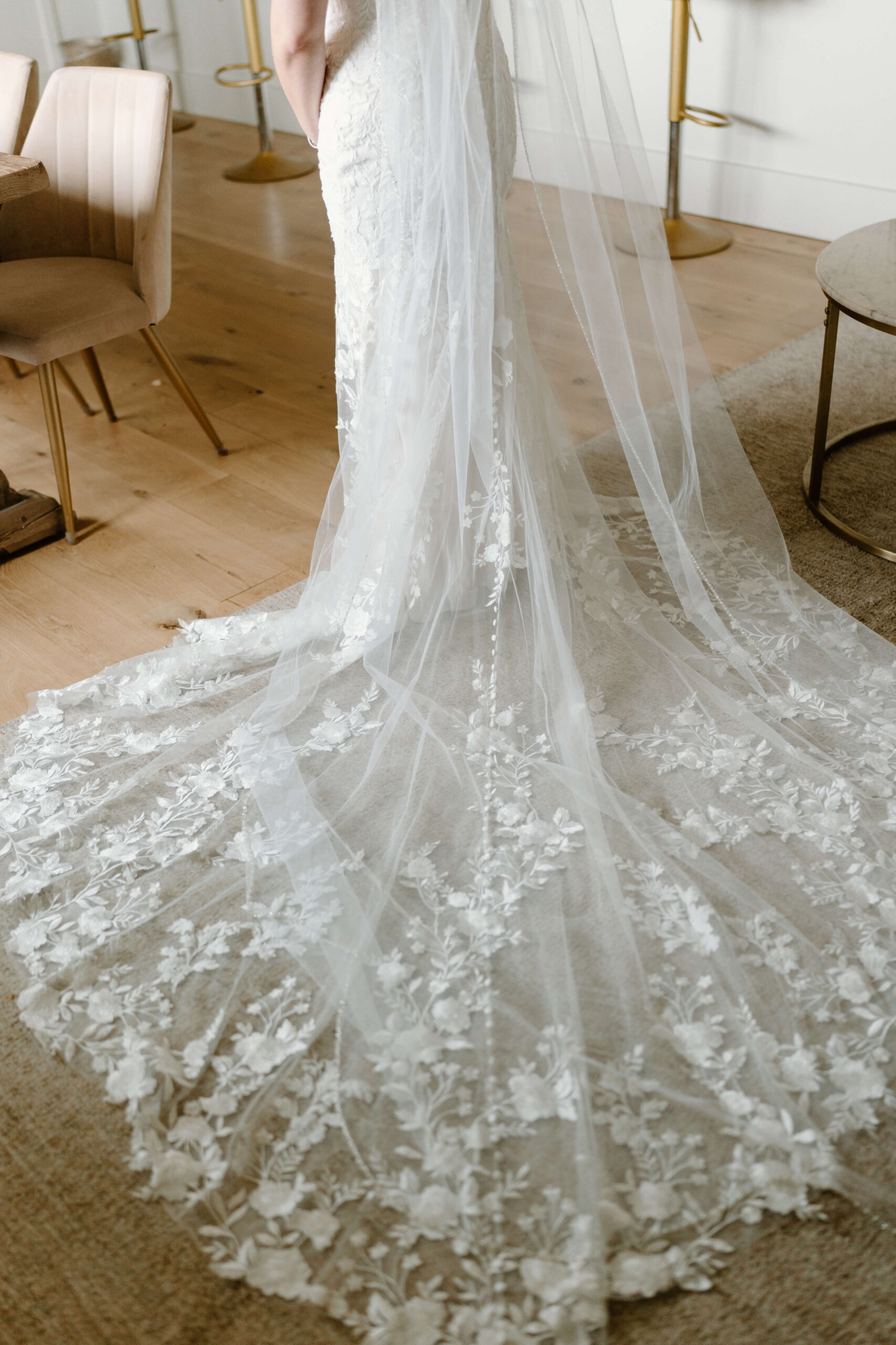 bride's train and veil laid out behind her in the bridal suite
