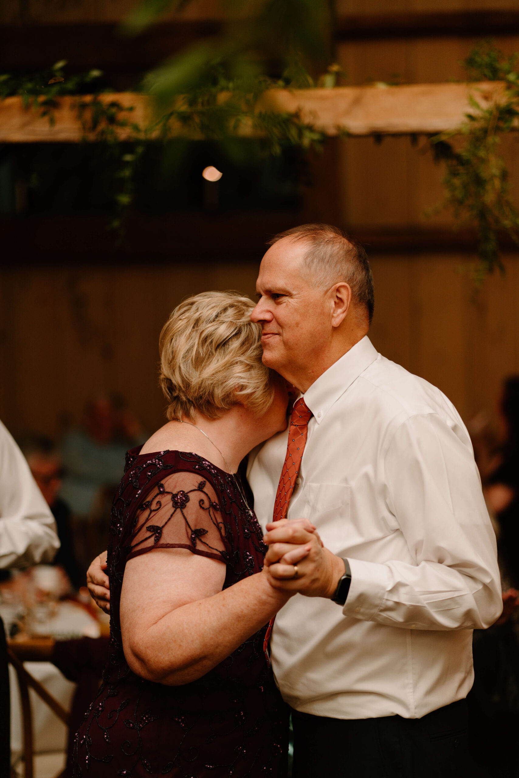 parents of the bride slow dancing during daughter's wedding reception