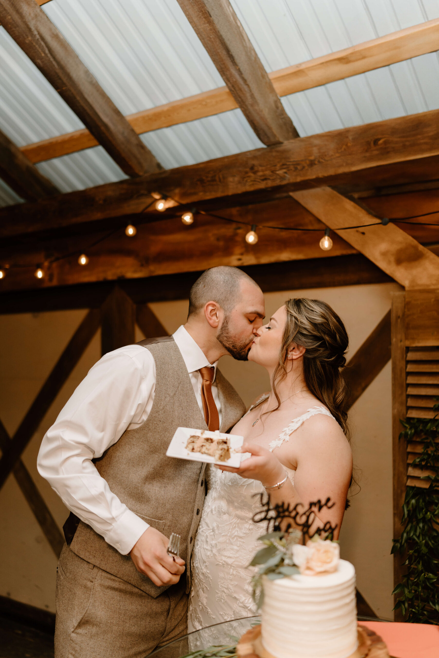 bride and groom kissing after their cake cutting