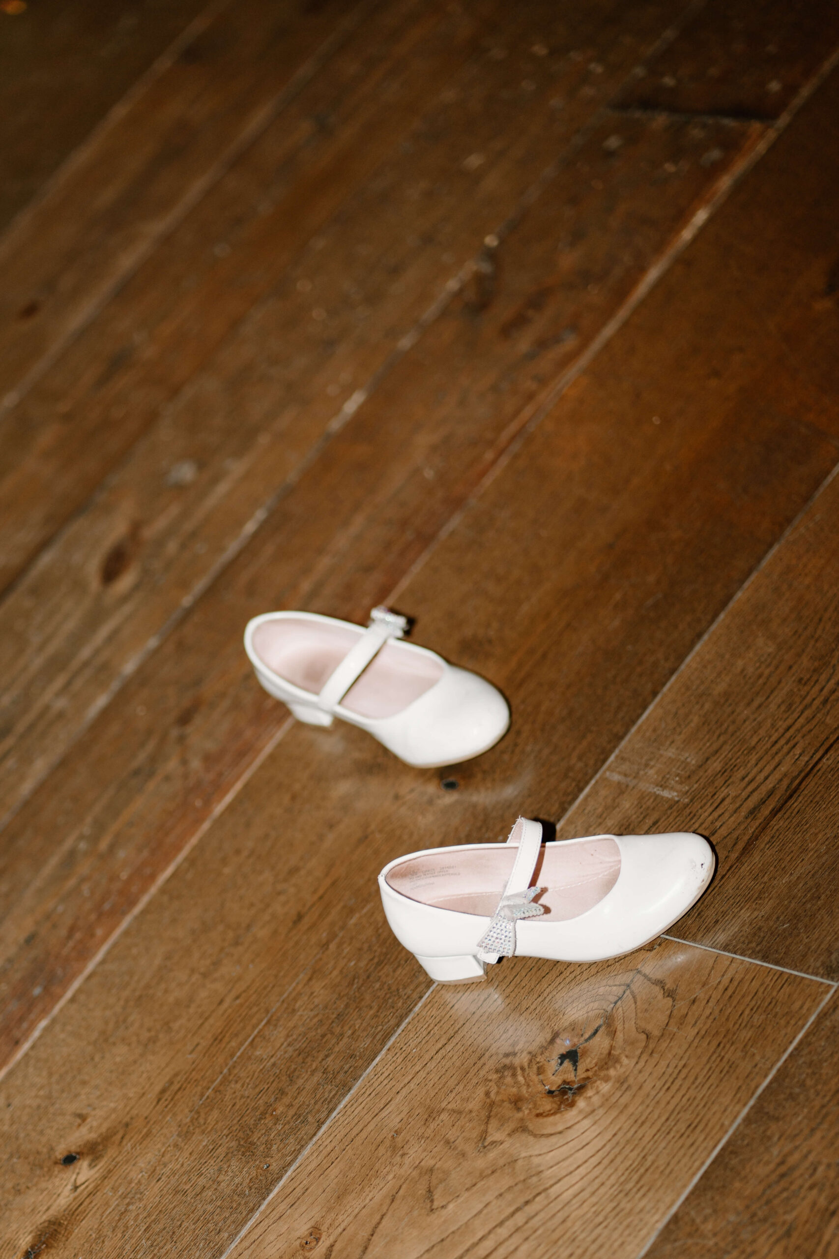 a tiny pair of flower girls' shoes kicked off during wedding reception