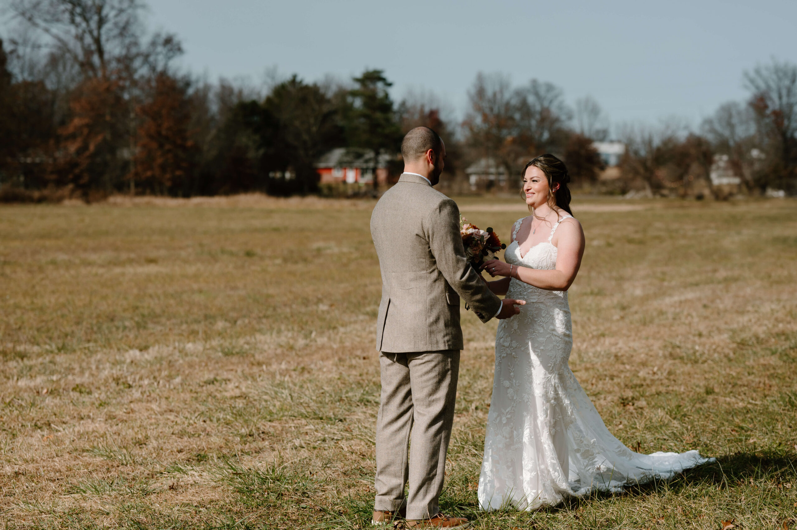 First look in a field between bride and groom on a beautiful November wedding day
